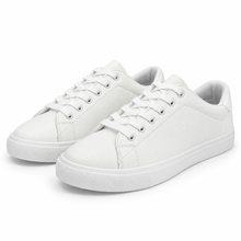 Pair, three-quarter view of textured all-white low-top sneaker.