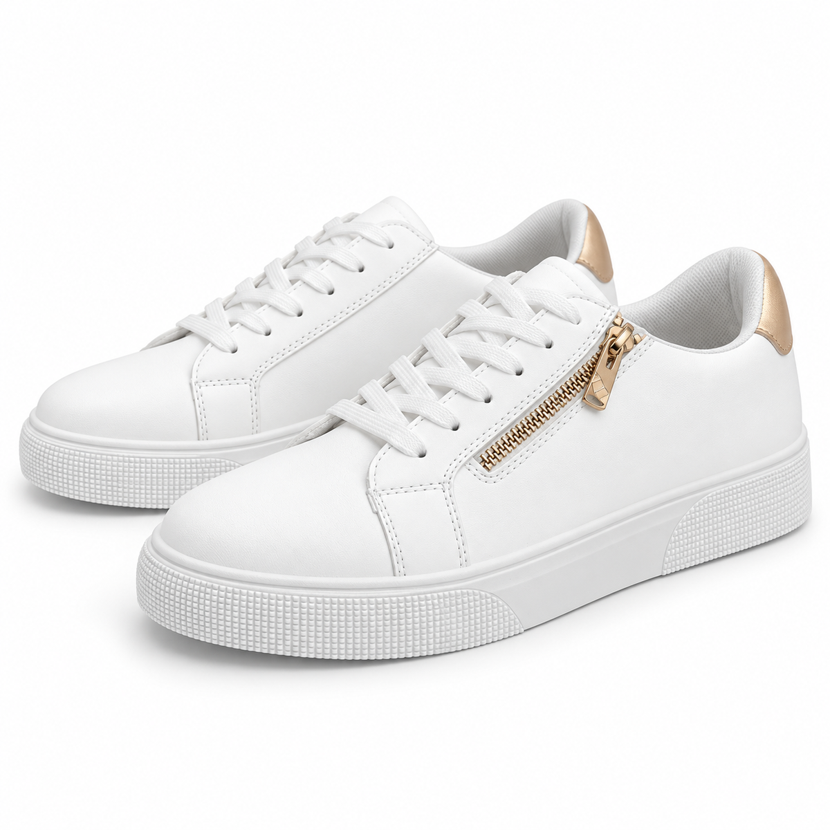 Pair of white low-top sneakers with gold-tone outer-side zippers and gold heel patches, three-quarter view.