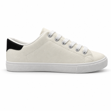 Opposite side profile of warm off-white low-top sneaker with black heel patch.