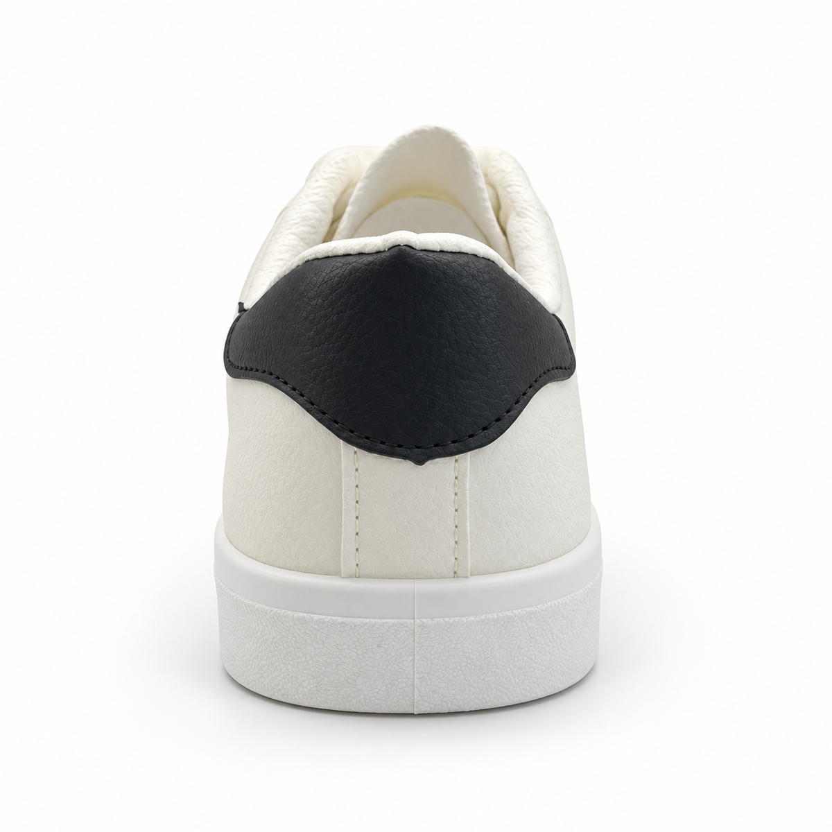 Rear heel view of warm off-white low-top sneaker with black heel patch.