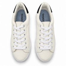 Pair, top view of warm off-white low-top sneaker with black heel patch.